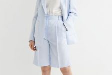 With white rounded earrings, white satin top, light blue linen long blazer and beige leather flat sandals