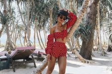 a beach party look in red and polka dot with an off the shoulder knotted crop top with long sleeves and shorts