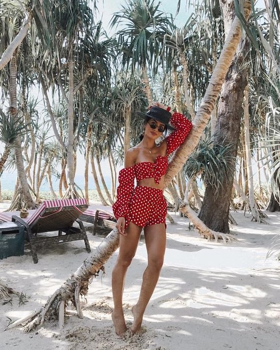 a beach party look in red and polka dot with an off the shoulder knotted crop top with long sleeves and shorts