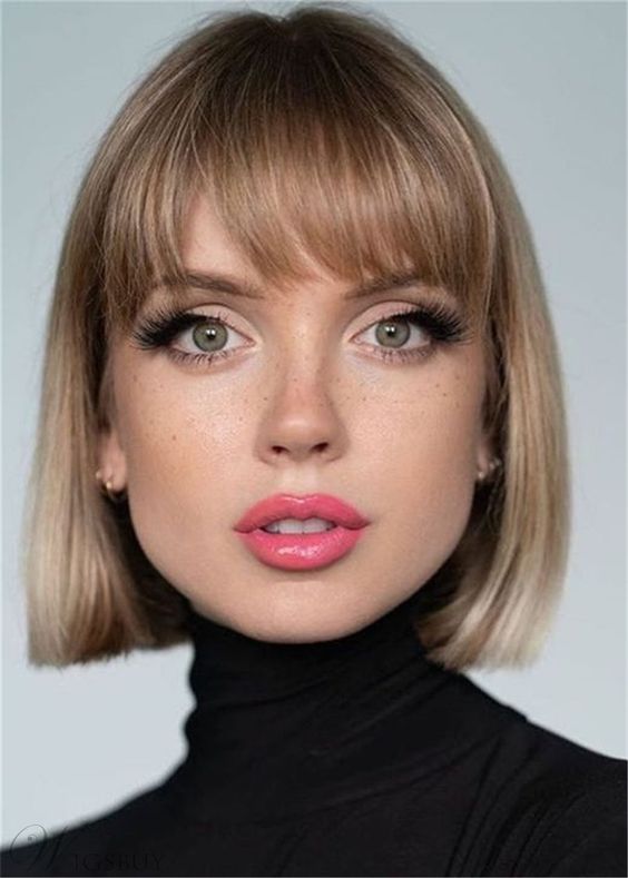 a beautiful natural blonde liquid bob with a classic fringe looks retro-inspired and extremely chic