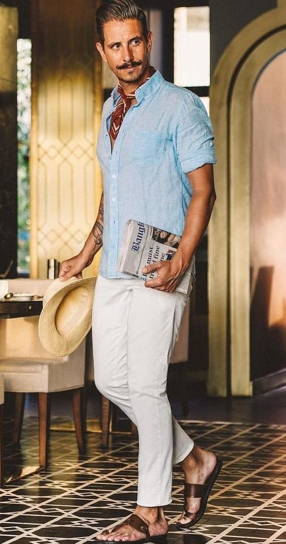 a blue linen shirt, white jeans, brown sandals and a bright neck tie plus a hat are cool for a hot day in summer