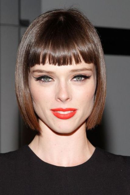 a catchy angular brown liqud bob with a fringe is a bold and catchy idea with an art deco feel