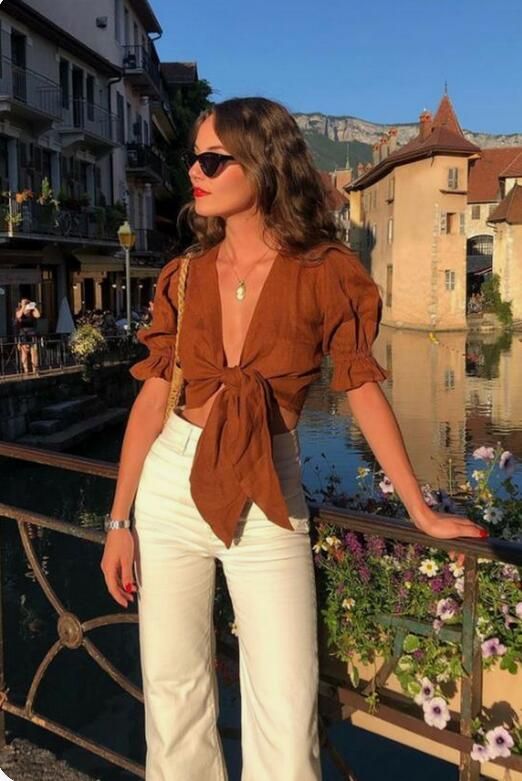 a catchy summer outfit with a brown wrap crop top, white jeans and a woven bag is awesome