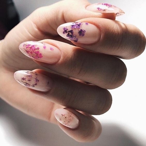 a chic blush manicure with colorful pressed blooms of purple and pink shades is a beautiful and girlish idea for summer