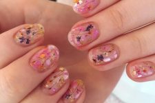 a clear manicure with colorful dried blooms and gold glitter touches is a gorgeous idea for a bright summer look