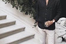 a contrasting summer outfit with a black linen shirt, neutral pants and black espadrilles for parties