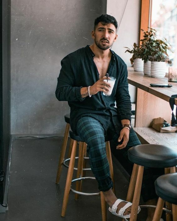 a dark summer look with a black linen long sleeve shirt, navy and blue checked pants and white birkenstocks