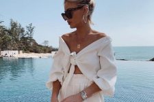 a light vacation look with an off the shoulder knotted crop top and shorts plus a statement necklace