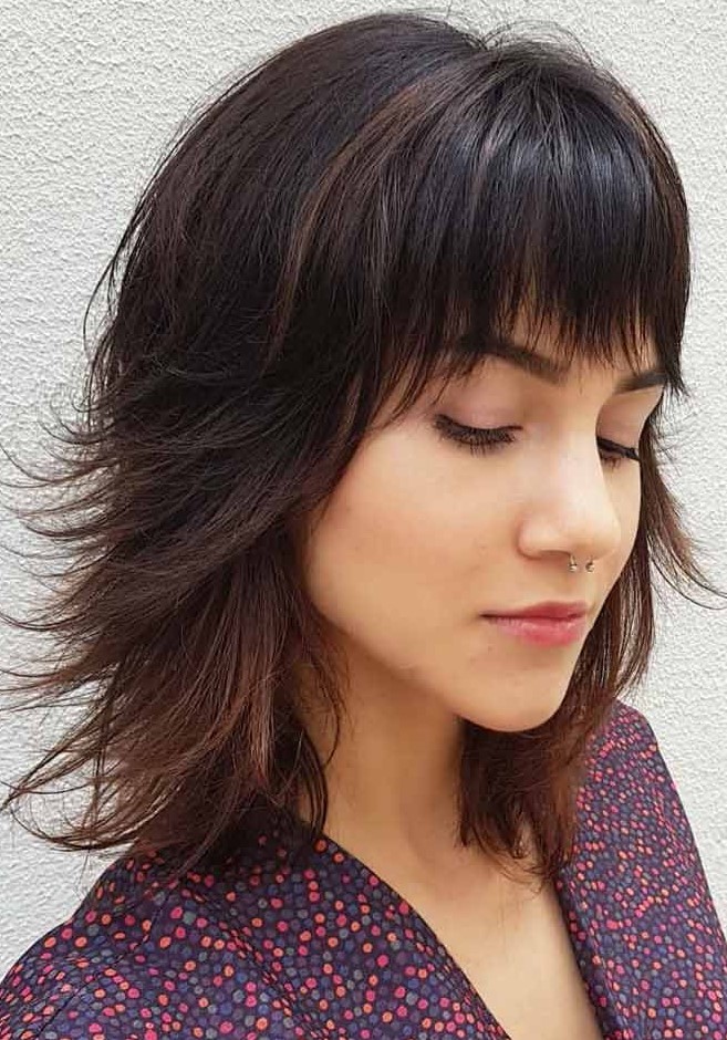 a long bob with bangs and flipped ends helps thinning hair look more voluminous and dimensional