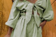 a lovely green linen suit of an off the shoulder crop top with puff sleeves and high waisted shorts for summer
