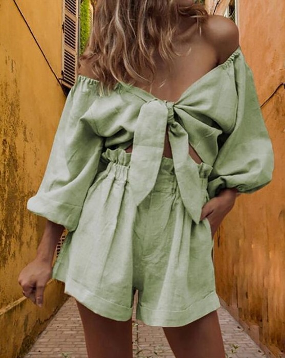 a lovely green linen suit of an off the shoulder crop top with puff sleeves and high waisted shorts for summer