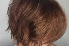 a peek-a-boo layered bob with a beautiful reddish tone and much volume is a glamorous and sexy girlish haircut