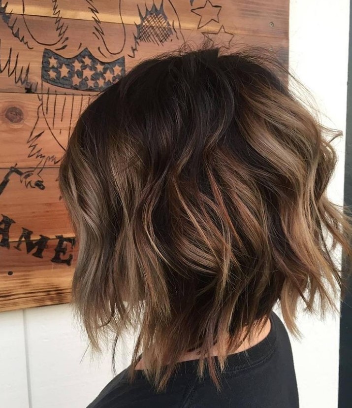 a razored layered bob with a darker root and caramel balayage looks dimensional and voluminous