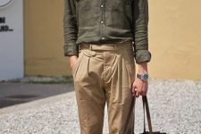 a stylish linen outfit with a green shirt, tan trousers, a brown bag and moccasins plus a neck tie