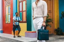a summer office look with a neutral linen shirt and white linen pants, brown birkenstocks and a teal bag