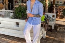 a summer vacation look with a blue linen shirt and white linen pants, a necklace and grey flipflops is an effortless idea