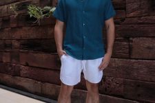 a teal linen shirt, white linen shorts, black birkenstocks are perfect for wearing them during vacation