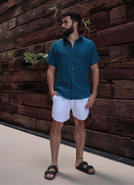 a teal linen shirt, white linen shorts, black birkenstocks are perfect for wearing them during vacation