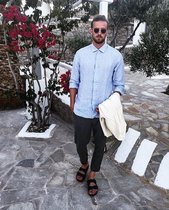 a total linen look with a blue shirt, black cropped pants, black birkenstocks and a neutral blazer