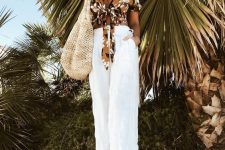 a vacation look with a brown floral print wrap top, white linen pants, neutral sandals and a woven bag