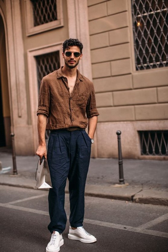 a very relaxed look with a brown linen shirt, navy linen pants, white sneakers is a cool idea to rock on a hot day