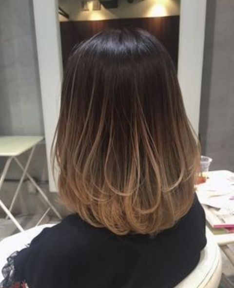 almost black medium-length hair with caramel babylights and matching ends to create a volume