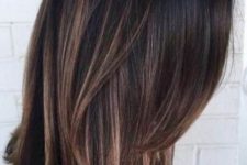 black dimensional hair with bright caramel balayage and babylights and ends that bring interest to the hairstyle