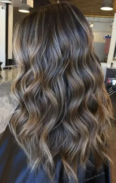 dark brunette hair with super fine caramel babylights that bring dimenion and highlight the color