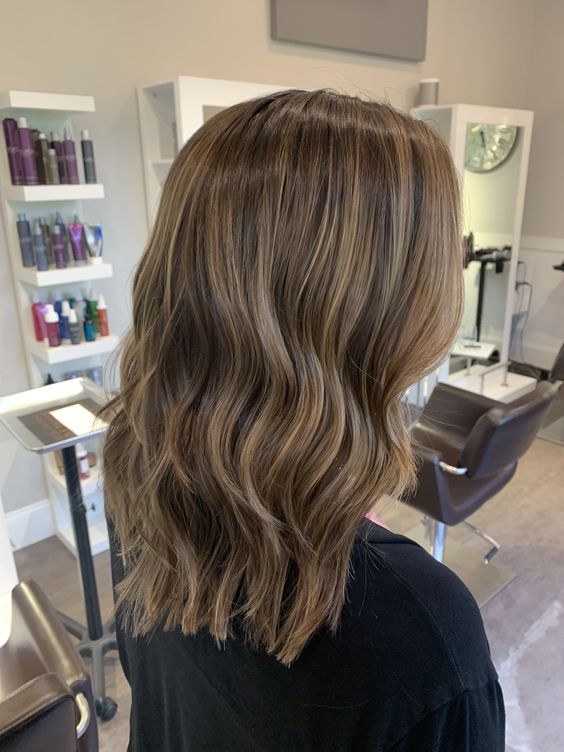 golden brown medium length hair with delicate blonde babylights that refresh the look and give interest to the main color