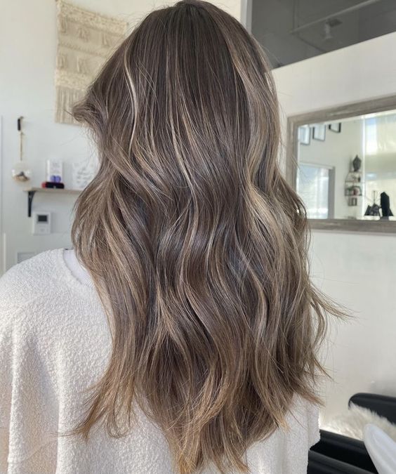 light brunette hair with blonde babylights that help create a bolder and more dimensional look