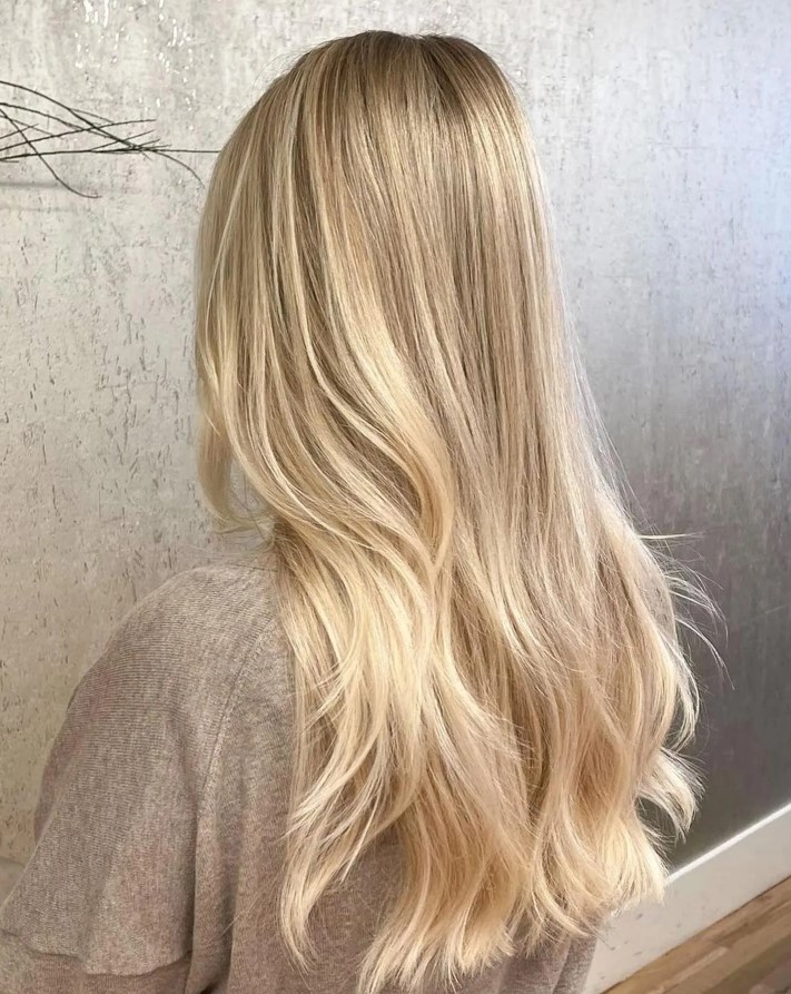 long blonde hair with subtle shiny babylights that make the color stand out even more and illuminate the face