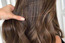 long dark brown hair with delicate honey and caramel babylights that help long strands look dimensional and bold