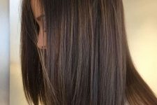 pretty medium-length dark brown hair with lovely caramel and lighter brown babylights looks chic and bold