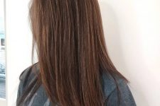 reddish brown long hair with subtle caramel babylights that add dimension and highlight the color of the hair