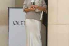 02 Rosie Huntington Whiteley wearing a grey turtleneck jumper, a white midi slip skirt and white strappy shoes plus a white bag