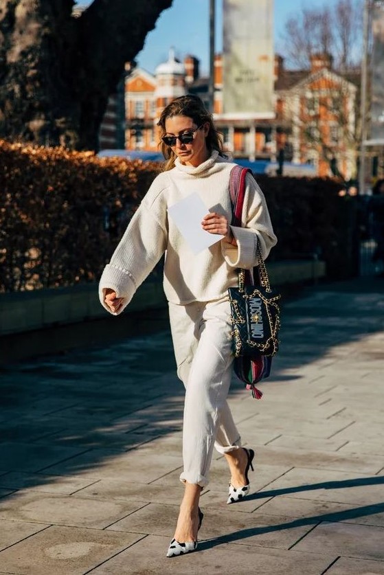 a neutral look with an oversized sweater, white jeans spruced up with black and white polka dot shoes and a catchy bag