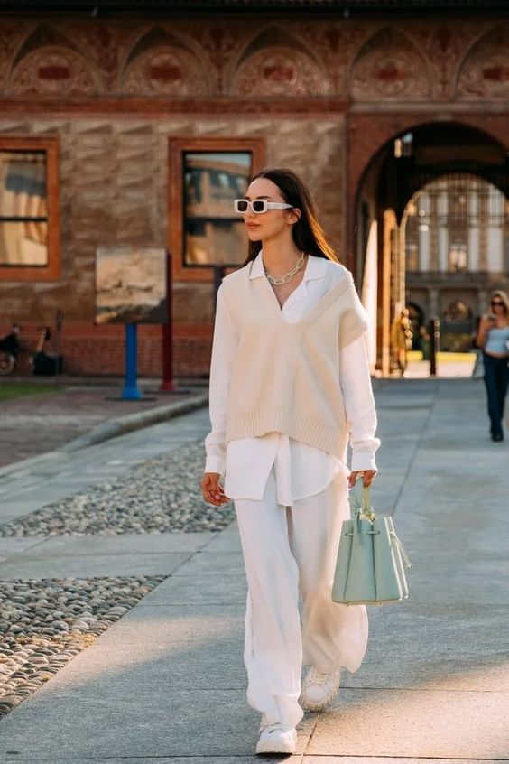 a relaxed white fall look with an oversized shirt, a tan waistcoat, white pants, a light green bag and white chunky shoes