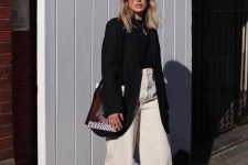 11 a fall work look with a black turtleneck and an oversized blazer, white wideleg jeans, black shoes and a woven bag
