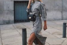 19 a grey plaid midi dress with puff sleeves and buttons on the shoulders, a red beret and red sock boots plus a black waistbag