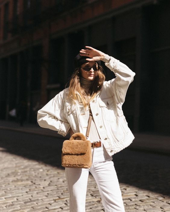 a pretty fall outfit with a white denim jacket and jeans, a tan turtleneck, a tan faux fur crossbody bag is amazing
