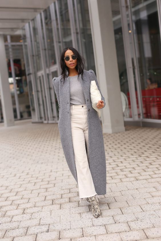 a sophisticated fall to winter look with a grey top, a grey maxi coat, white wide jeans, snakeskin printed boots and a white bag