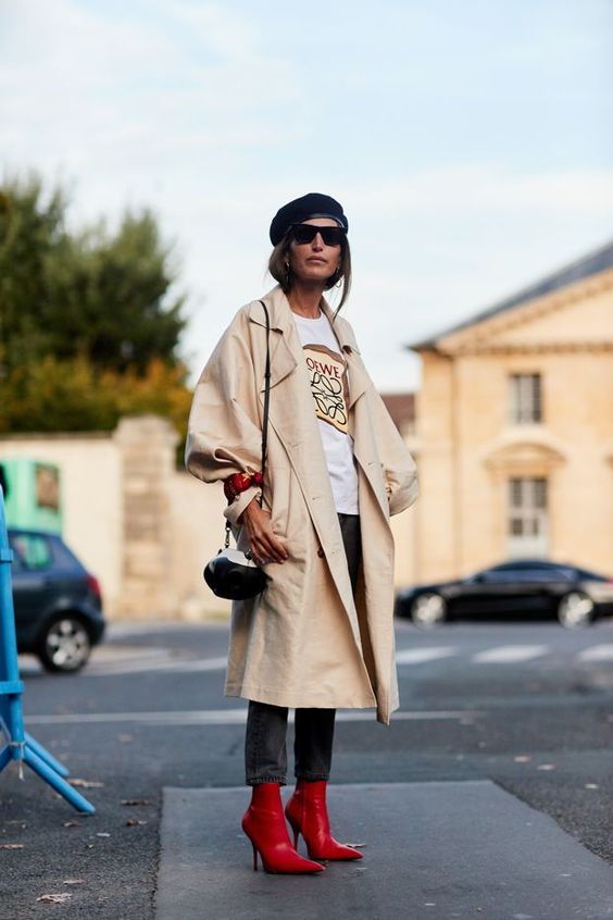 a printed t shirt, black jeans, a tan oversized trench and red boots, a small bag and a beret for the fall