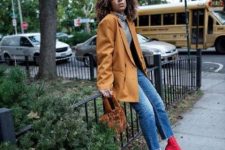 24 a striped turtleneck, blue cropped jeans, red sock boots, a mustard oversized blazer and a brown velvet bag