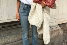 26 a white shirt with puff sleeves, blue cropped jeans, hot red booties, a chunky knit creamy jumper and a large clutch