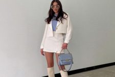27 a white skirt suit with a cropped jacket, a mini skirt, a lilac turtleneck, white knee boots and a lilac bag