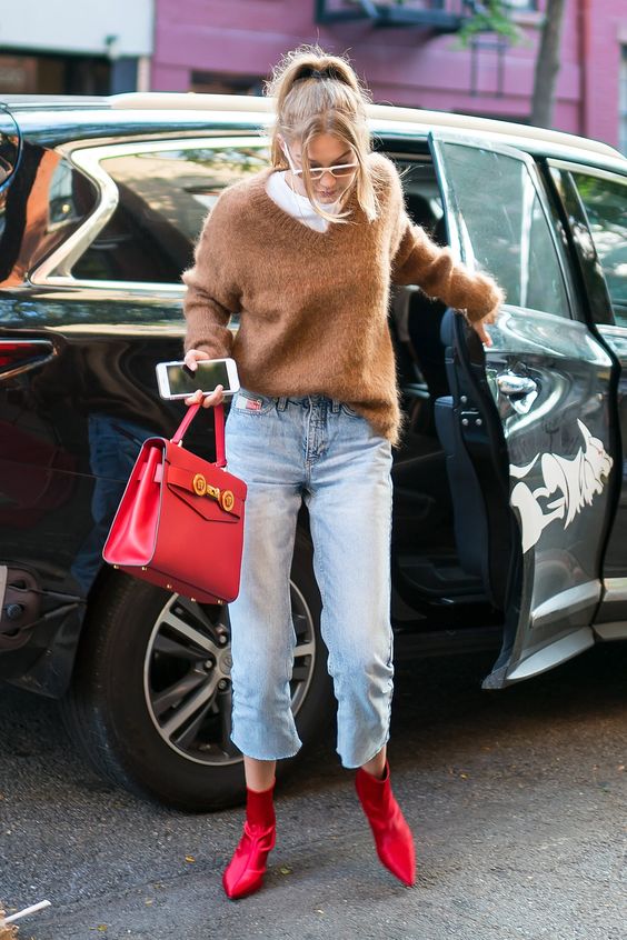 a white t shirt, a brown jumper, blue cropped jeans, hot red boots and a hot red bag for wearing this fall