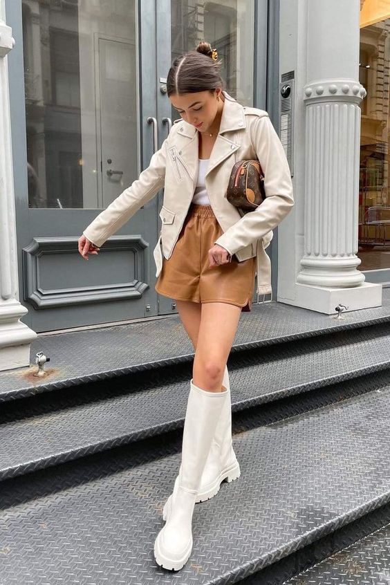 a white top, tan leather shorts, a creamy leather jacket and creamy tall boots plus a brown bag for the fall