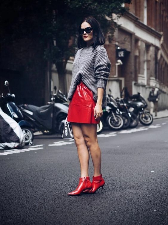 an oversized grey jumper, a red leather mini skirt, red kitten heel booties for a chic fall look