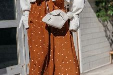 33 a rust-colored polka dot midi dress, a white denim jacket, a white mini bag, brown boots for fall