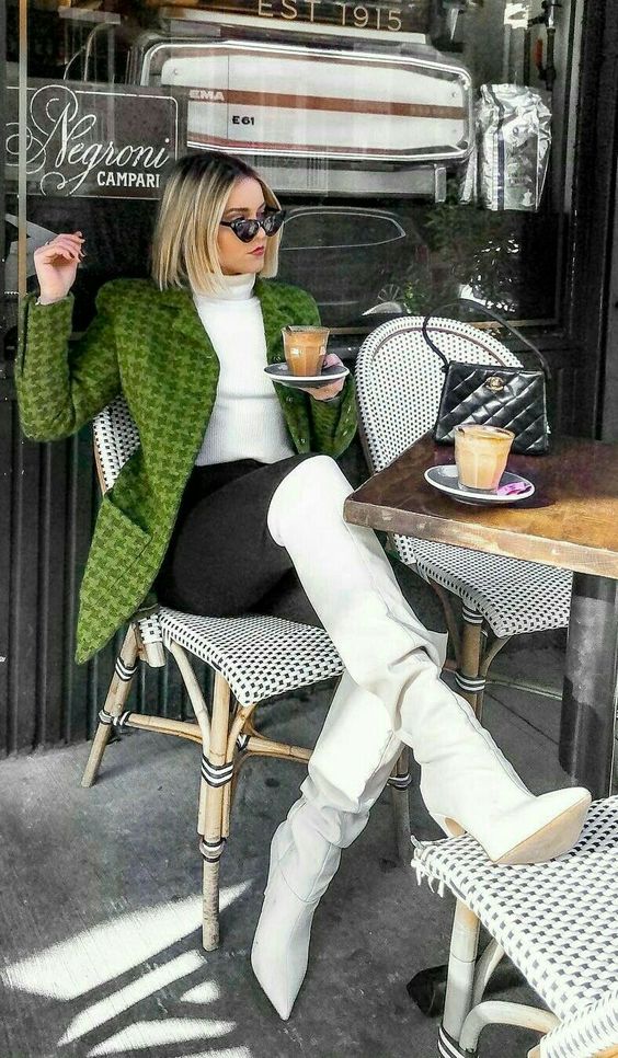a white turtleneck, black skinnies, a green printed blazer, white knee boots and a small black bag for a chic fall look